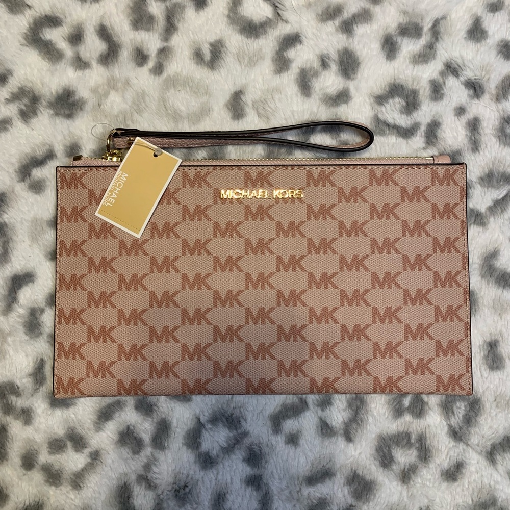 This monogram Michael Kors wristlet in pink is beautiful! BRAND NEW WITH TAGS!